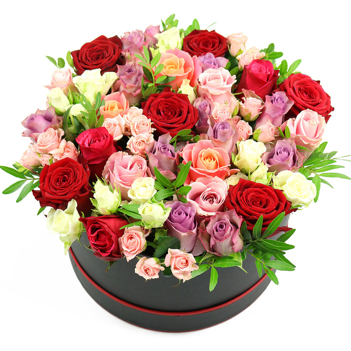 Against a brilliant white background, a round black hatbox brims with roses arranged into a lush, domed display that seems to overflow with colour and texture. The cylindrical box is solid and refined, its deep black surface finished in a smooth matte that quietly absorbs light. A delicate red trim at the base acts like a fine border, offering a subtle nod to the romantic hues within, much like a carefully chosen accent in a Finsbury townhouse interior. Rising from this understated foundation is a dense canopy of roses, shaped into a generous sphere that extends beyond the rim in every direction. The bouquet is dominated by velvety crimson and true red roses, their petals spiralling inward in layered whorls that convey warmth and devotion. These are entwined with romantic fuchsia and soft blush pink roses, warm coral and peach tones adding a gentle glow, and creamy white blooms that lift and brighten the palette. Cool notes of lavender and muted purple roses are woven through the arrangement, bringing sophistication and depth to the colour story. A variety of bloom sizes is visible: some roses are small and tightly furled, others partially open with slightly ruffled edges, and a few are fully open, showcasing their intricate centres. Interspersed between the blossoms, slender sprigs of fresh green foliage peek out, providing subtle contrast and an impression of garden freshness, like glimpses of greenery along nearby Finsbury streets and courtyards. The lighting is even and natural, enhancing the velvety textures of the petals and the clean, modern lines of the hatbox. Altogether, the image suggests a premium floral gift ideal for birthdays, anniversaries, or thoughtful romantic gestures, the sort of refined arrangement Finsbury Flowers might prepare for same-day delivery across the local area.