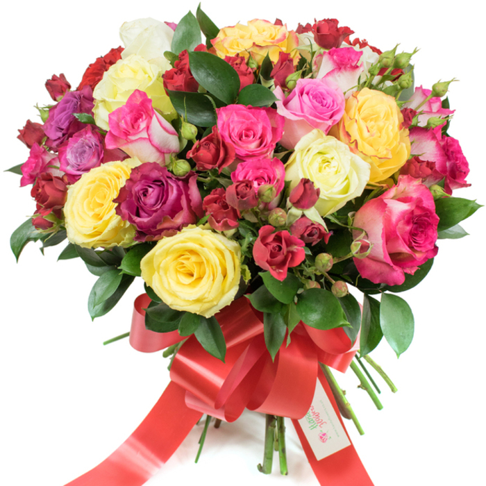 Viewed against a stark white studio backdrop, this opulent hand-tied bouquet showcases premium roses in an artfully abundant, domed composition. A lively mix of flower types creates the visual story: fully opened hybrid tea roses offer dramatic, ruffled centres while smaller clustered spray roses and tight buds create depth and tactile contrast. The colour story is joyful and rich - bright yellow roses radiate optimism, creamy ivory blooms soften the mix, and a range of pinks from muted blush to vivid fuchsia and bicoloured pink-and-white petals bring playful contrast. Deep crimson and burgundy roses are threaded through the arrangement to anchor the palette and add romantic weight. Dark-green, glossy foliage, likely ruscus or salal, breathes life into the bouquet and frames each blossom so the colours read with clarity.

The stems are neatly gathered and finished with a wide, eye-catching red satin ribbon tied into a sweeping bow with long tails; a petite white tag tucked into the ribbon reads Happy Holidays, giving the bouquet a festive, gift-ready feel. The soft studio light reveals petal texture and the bouquet's lush volume, and the imagined perfume is clean, slightly citrus-bright rose scent that feels uplifting rather than overpowering. Crafted with the care of a local florist, this arrangement would suit birthdays, anniversaries or seasonal celebrations across Finsbury and nearby streets like Old Street or Goswell Road, and is available for careful local delivery from Finsbury Flowers for those who want a beautiful, heartfelt gesture.