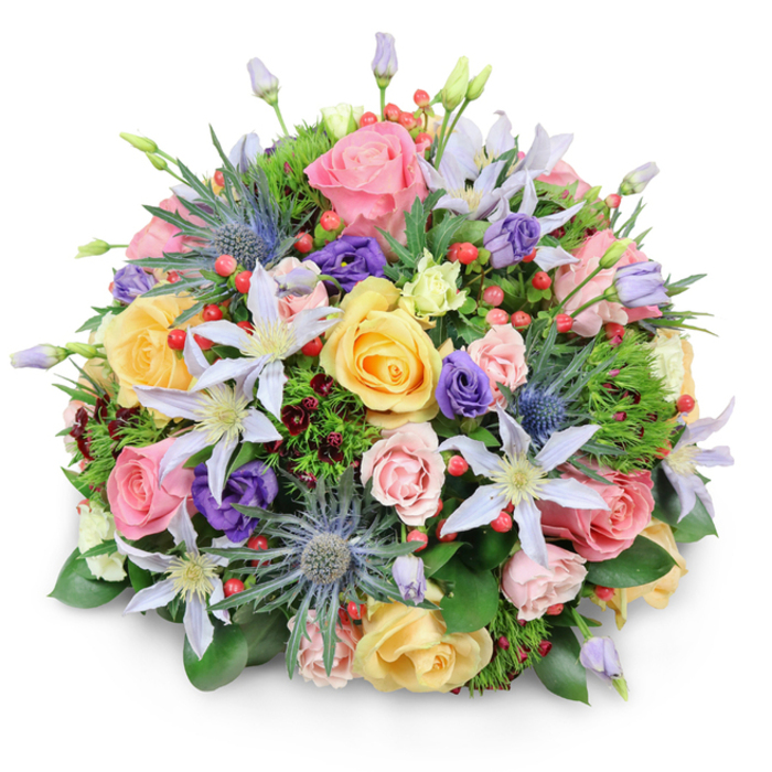 In this image, a meticulously crafted round bouquet is set against a spotless white background, its shape and colours given full attention without distraction. The arrangement forms an elegant dome, carefully balanced so that every flower and leaf contributes to a sense of fullness and gentle movement, much like a display waiting in the window of Finsbury Flowers. At the heart of the bouquet, garden roses in soft pink, warm yellow, and delicate peach unfold in sumptuous spirals, each bloom layered with many fine petals that catch and soften the light. Nestled among them are clematis flowers, their long, pointed petals in white and pale lavender radiating from bright yellow centres, suggesting a touch of wildness, as though they were plucked from a hidden garden off Amwell Street. The romance of the roses and clematis is cleverly contrasted by striking blue eryngium-sea holly-whose small, spherical heads and spiky bracts in metallic blue-grey add a bold, textural highlight. Rich purple lisianthus blooms appear between the larger flowers, some tightly furled, others unfurling into cupped blossoms, giving shifts in tone and depth across the arrangement. Bright red hypericum berries are scattered like tiny jewels, their smooth, rounded forms catching the light and bringing a playful accent to the softer shapes. All of this is supported by a generous framework of greenery: glossy broad leaves that outline the bouquet's rounded base, light, feathery foliage that adds airiness, and hints of darker, burgundy-tinged stems that introduce gentle shadow and contrast. The overall mood is one of sophisticated joy and heartfelt sentiment, ideal for marking milestones in Finsbury-be it a birthday near Exmouth Market, a quiet anniversary in a Clerkenwell flat, or a thoughtful gesture of appreciation sent to an office near Finsbury Square.