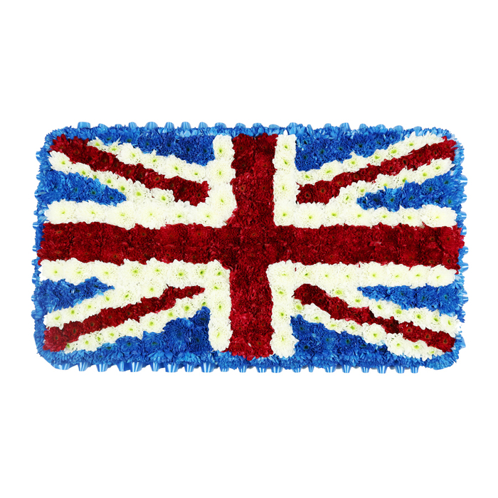 A solemn and intricately crafted floral Union Jack fills this image, its rectangular shape fully occupied by meticulously arranged flowers in the traditional red, white, and blue of the United Kingdom's flag. Placed against a stark white background, the composition draws attention entirely to the floral craftsmanship and the symbolic pattern. Deep blue blossoms create the foundation, packed closely together until they resemble a dense, velvety carpet running along the edges and into each quadrant. These blue sections frame the wide, prominent St. George's Cross, built from thousands of rich red flowers whose layered petals catch the light softly, lending warmth to the otherwise formal design. Thin, bright white floral bands track the outlines of this central cross, providing sharp contrast and maintaining the strict geometry of the flag. Diagonal red stripes cut smoothly from corner to corner, standing in for St. Patrick's Cross, and these, too, are edged with white blossoms that also represent St. Andrew's Cross, completing the full heraldic design. Every angle is sharp, every line crisp, demonstrating a florist's careful planning and steady hand. The overall effect is both regal and tender: a powerful patriotic emblem expressed through something as fragile and transient as fresh flowers. In Finsbury, where old streets meet contemporary city life, this kind of tribute would be especially resonant at funerals or remembrance events for those who served their country, long-time local residents, or families wishing to emphasise British heritage. It might be delivered to a service near Farringdon, a small chapel off Rosebery Avenue, or a crematorium further afield, carrying with it the soft scent of fresh blooms and the enduring message of honour and respect.
